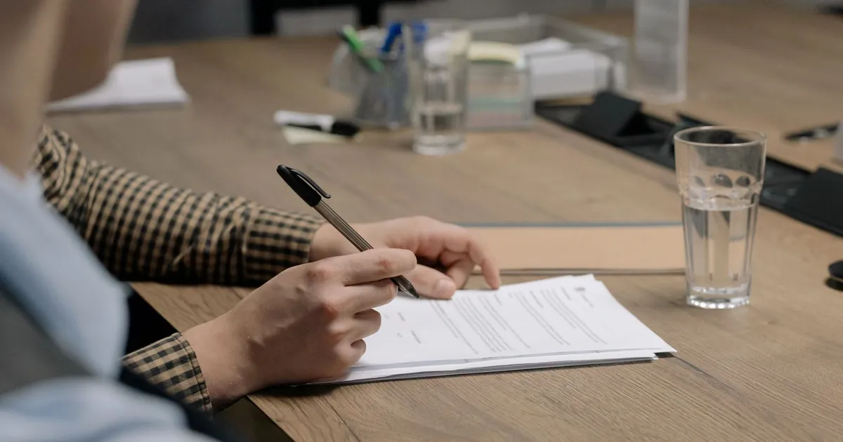 Pay stubs, bank statements and ID laid out on a desk for a payday loans no bank verification application